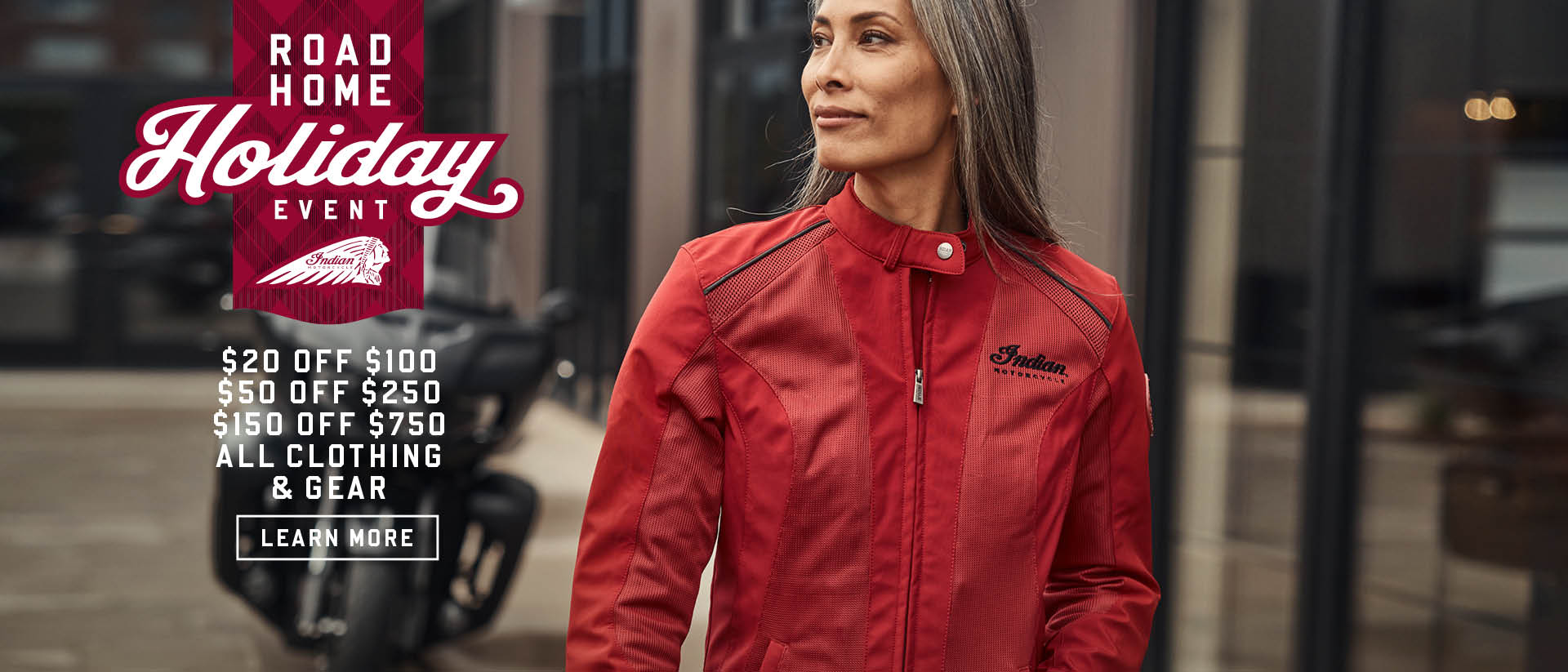 Female wearing new Indian Motorcycle Red Jacket. Promotional Offer: $20 off $100, $50 off $250, $150 off $750 all clothing & gear 